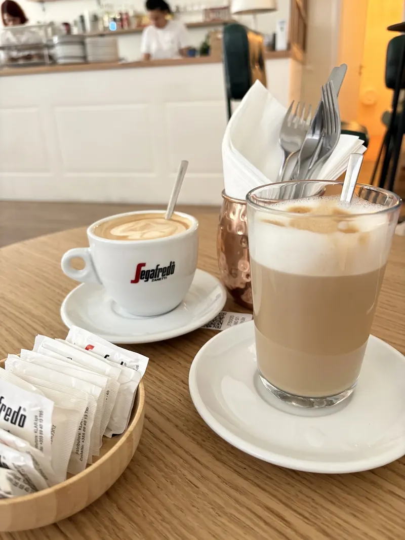 A cappuccino and a caffè latte on a wooden table