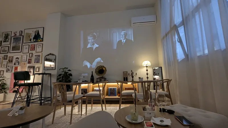 A black-and-white film projected on the dining-room wall
