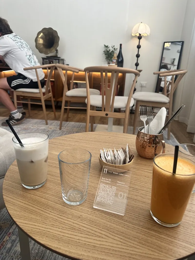 Iced coffee, water and fresh orange juice on a round café table