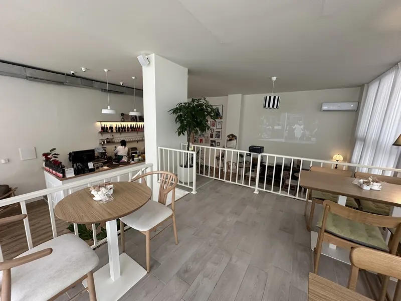 The bright dining room with wooden chairs and round tables